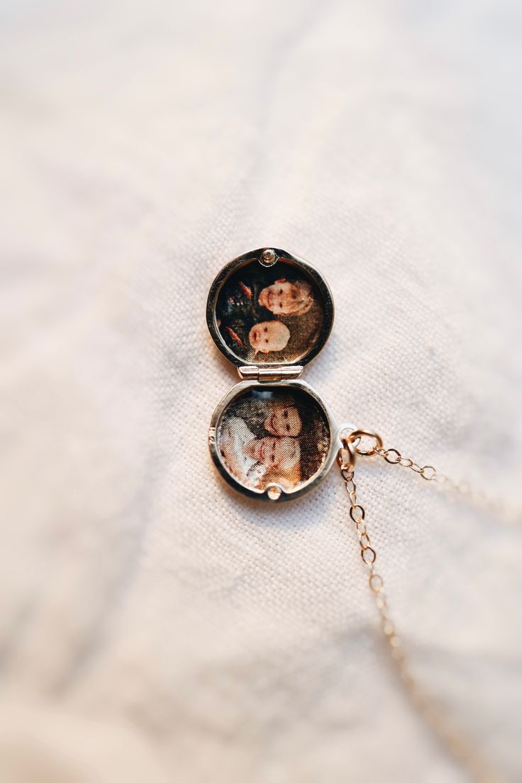 A luxury solid gold or silver locket with your photos transferred onto the metal. Minimal enough to wear everyday and high enough quality to last a lifetime. What Makes it Special:• Something like this literally does not exist! We developed our own unique process, where the photos blend into the metal itself. The color of the metal shines through the image, making it look like the luxury heirloom that it is.• It will last. Think of it as a piece you’ll wear every day and your grandchildren will Engraved Round Pendant Jewelry For Personal Use, Engraved Round Pendant Necklace For Personal Use, Sterling Silver Pendant Jewelry, Customizable Heirloom Style Jewelry Gift, Heirloom Rose Gold Jewelry For Keepsake, White Gold Pendant Locket Necklace For Keepsake, Heirloom Personalized Jewelry For Memorial, Vintage Locket Jewelry For Personal Use, Round Locket Jewelry For Personalized Gift