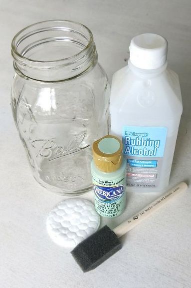 the contents of a mason jar, paintbrush, and toothpaste on a table