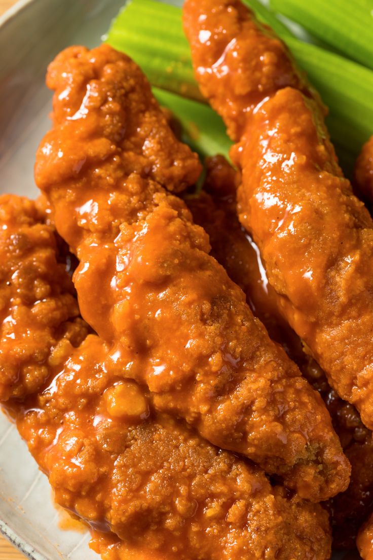 chicken wings with sauce and asparagus on a glass plate, ready to be eaten