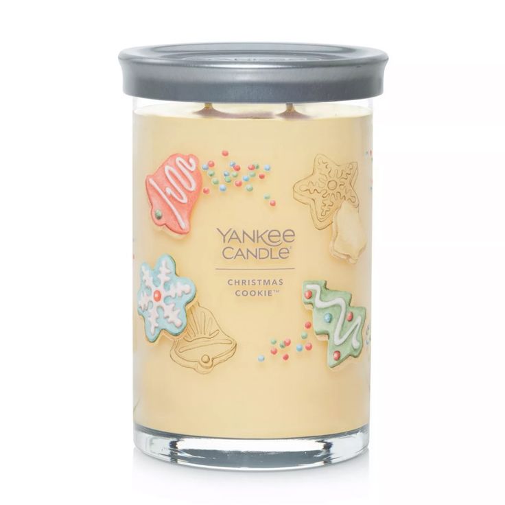 yankee candle with christmas cookies on the front and bottom, in a glass jar against a white background