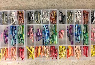 several plastic containers filled with assorted colored pencils