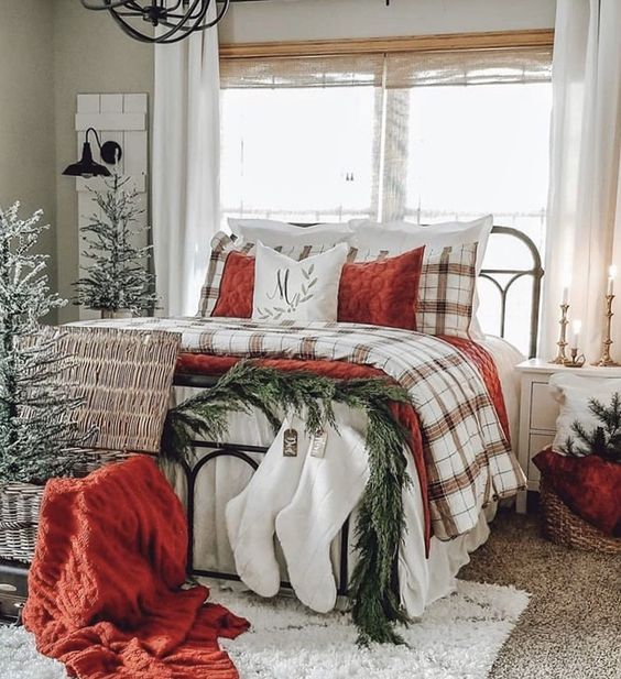 a bedroom decorated for christmas with red and white decor