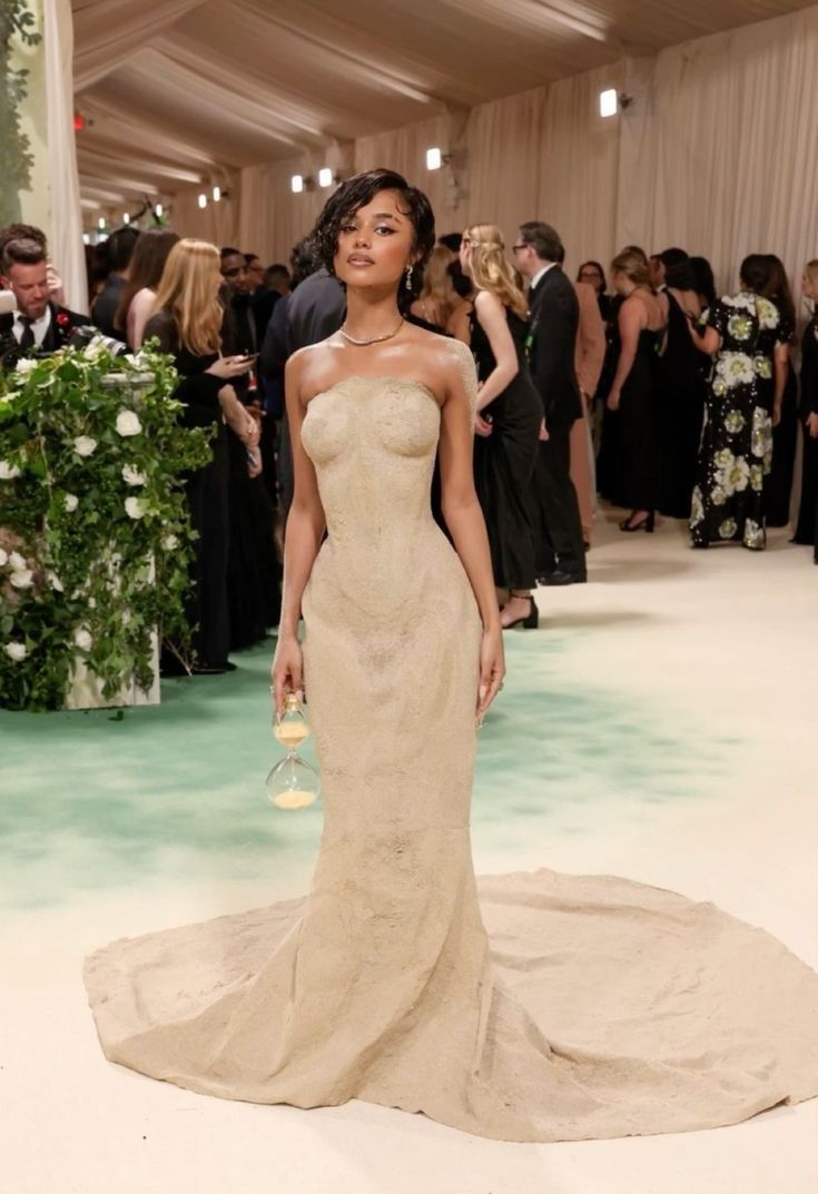 an image of a woman in a wedding dress at the mete opera performance with other people around her