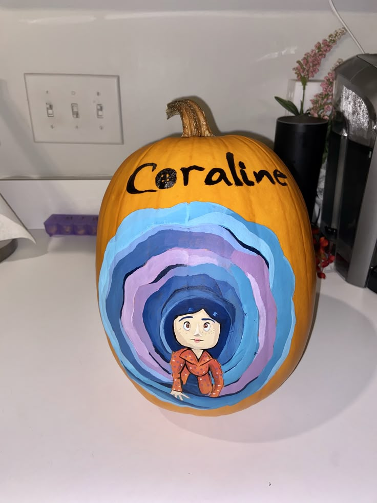 a painted pumpkin sitting on top of a counter