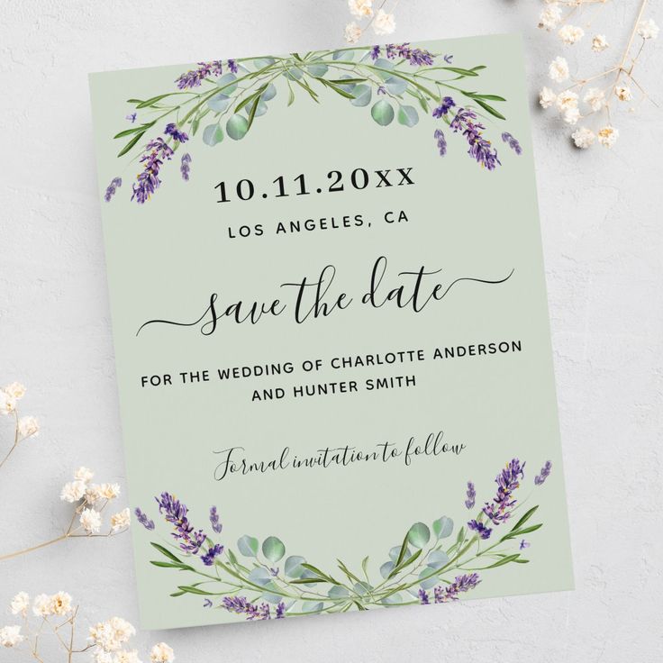 wedding save the date card with lavender flowers and greenery on it, surrounded by baby's breath