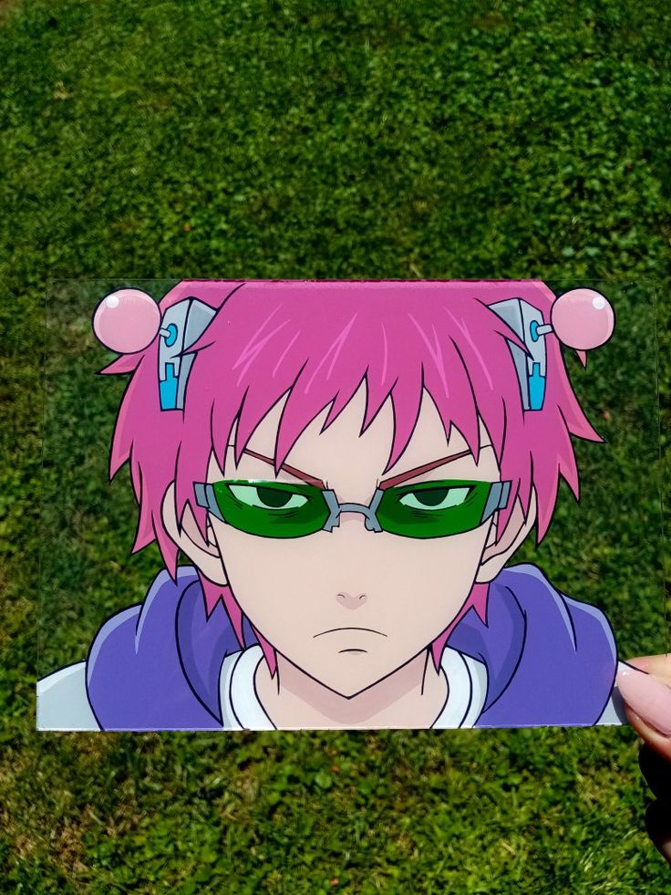 a person holding up a sticker with pink hair and green eyes