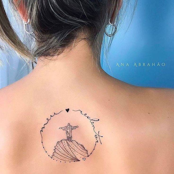 the back of a woman's neck with a tattoo on it