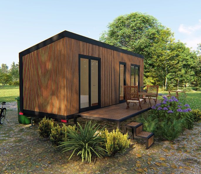 a small wooden house sitting on top of a lush green field