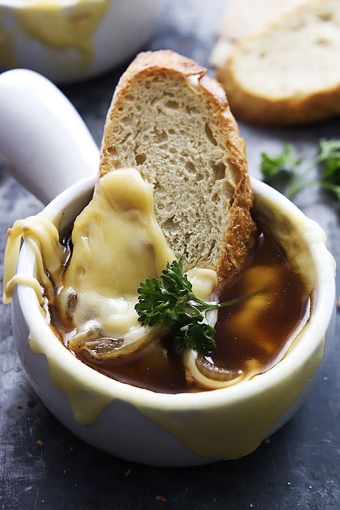 a bowl filled with soup and bread on top of a table