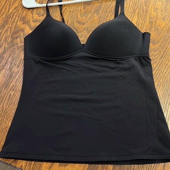 Never Worn, Size M. Very Stretchy Material And Adjustable Straps. The Cups Are Structured But No Underwire. About 13” -14” Across Busy And The Bottom, Approximately 21” Long. Solid Color Low-cut Bra-friendly Top, Low-cut Bra Friendly Top, Stretch Low-cut Tops Bra Friendly, Stretch Low-cut Bra Friendly Top, Low-cut Tank Top With Built-in Bra, Solid V-neck Top With Built-in Bra, Shapewear Camisole Tops With Removable Bra Pads, V-neck Bra Friendly Top For Night Out, Low-cut Camisole With Built-in Bra For Night Out