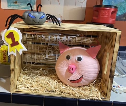 a piggy bank in a crate with some decorations on it