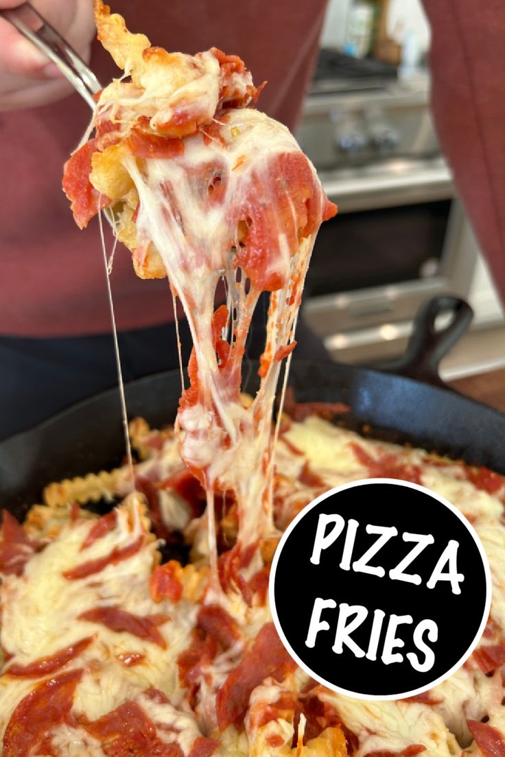 a person is taking a slice of pizza from a pan with the words pizza fries on it