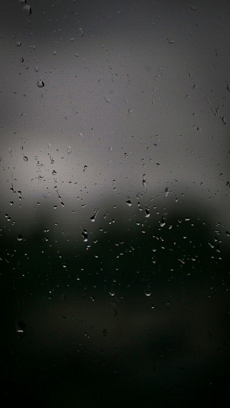 rain drops on the window and dark sky in the backgrounnd, as seen from outside