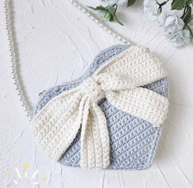 a crocheted purse with a bow on it