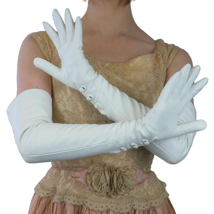 Long White Leather Gloves for Bridal, Debutante, Opera and Formal The ultimate sensual elegance for a woman is to wear these 16-button long opera leather gloves imported from Italy. The three buttons at the wrist open to allow your hands to be free without removing the gloves. Made of the softest kidskin leather. They reach halfway between the elbow and the shoulder. Made for bridal wear at weddings, opera, debutante affairs and formal occasions. Total length of this 16-button length glove is 24 White Leather Gloves, Opera Length Gloves, Long Leather Gloves, Elegant Gloves, Formal Gloves, Opera Gloves, Bridal Gloves, Black Leather Gloves, Chunky Knit Blanket