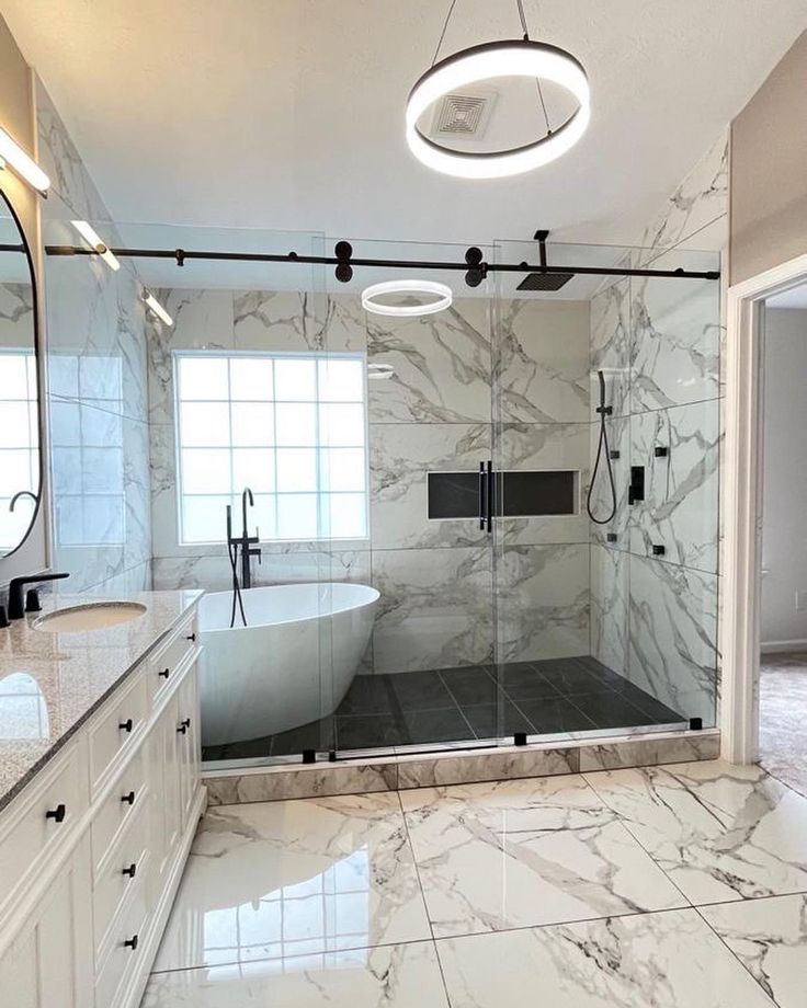 a large bathroom with marble floors and white walls, along with a walk in shower