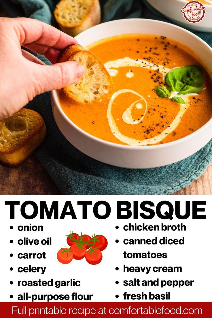 a person dipping some bread into a bowl of tomato soup