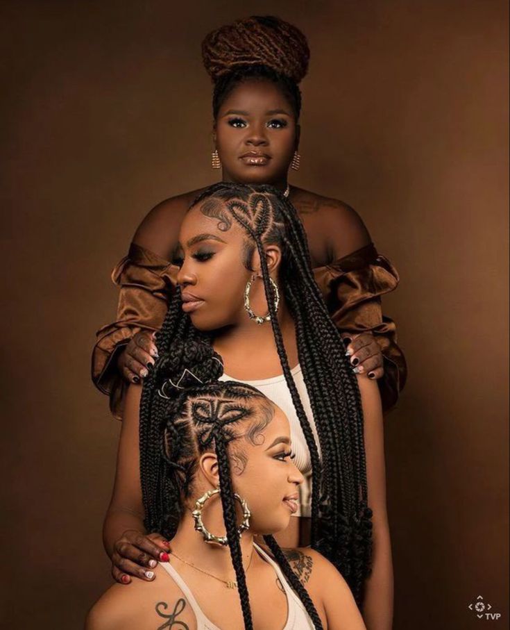 three women with braids and tattoos on their heads