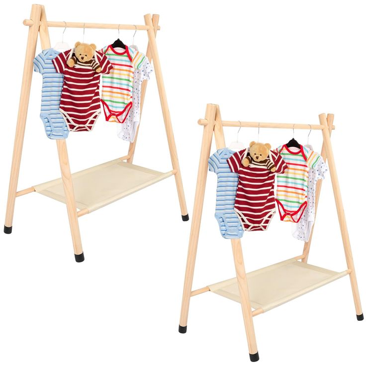 two wooden clothes racks holding baby's sweaters and onesuits on them