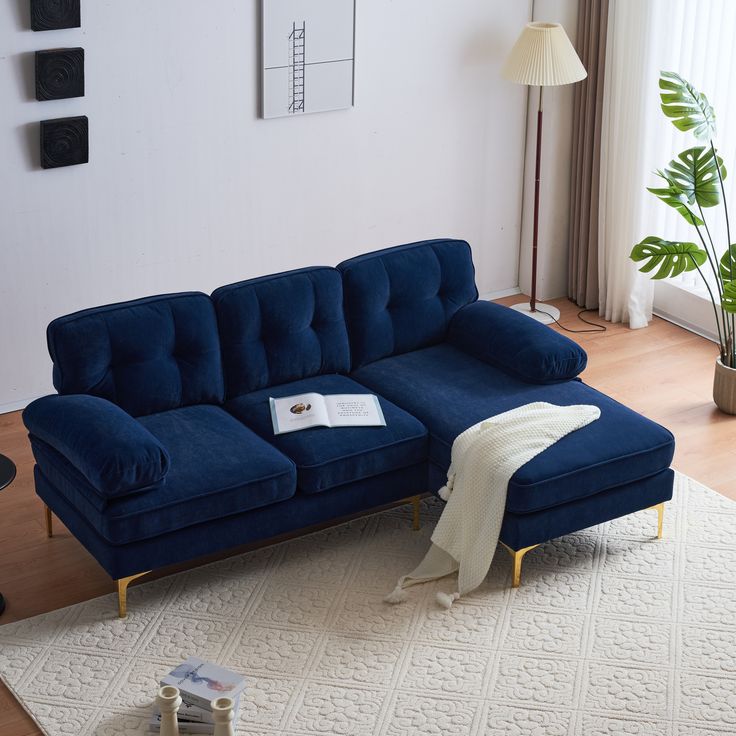 a blue couch sitting on top of a white rug