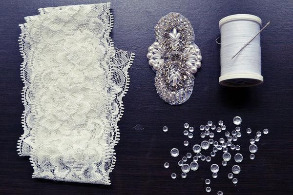 lace, beads and spools of thread on a table