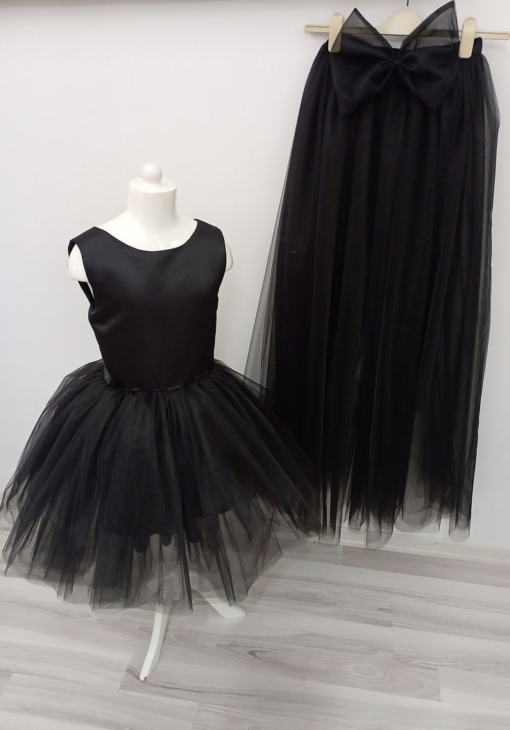 If you want, you can remove the tail and use it as a mini dress. It is a very functional tulle dress. Fitted Tulle Dress For Dress-up, Elegant Long Train Dresses For Spring, Elegant Long Train Spring Dresses, Stretch Tulle Evening Dresses, Fitted Tulle Skirt Evening Dress, Black Mini Length Tulle Dress, Black Mini Dress With Tulle Skirt, Black Tulle Mini Dress For Evening, Black Mini Tulle Dress