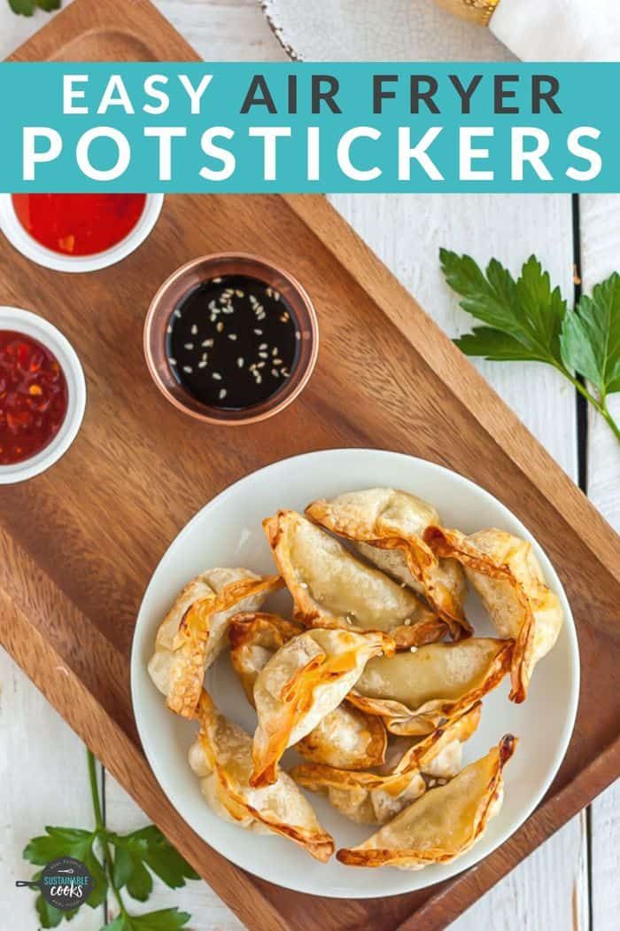 air fryer potstickers on a cutting board with dipping sauces and herbs