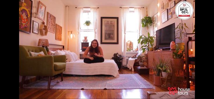 a woman sitting on top of a bed in a living room