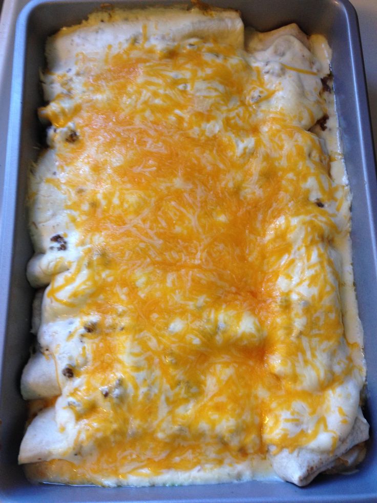 a casserole dish with cheese and meat in it