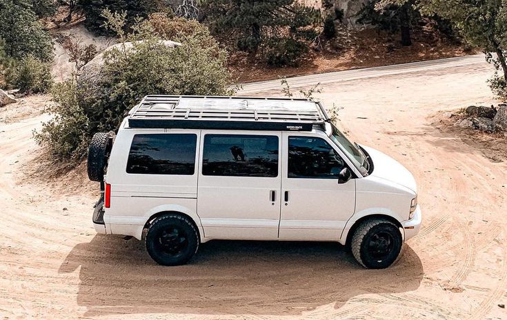 a white van is parked in the dirt