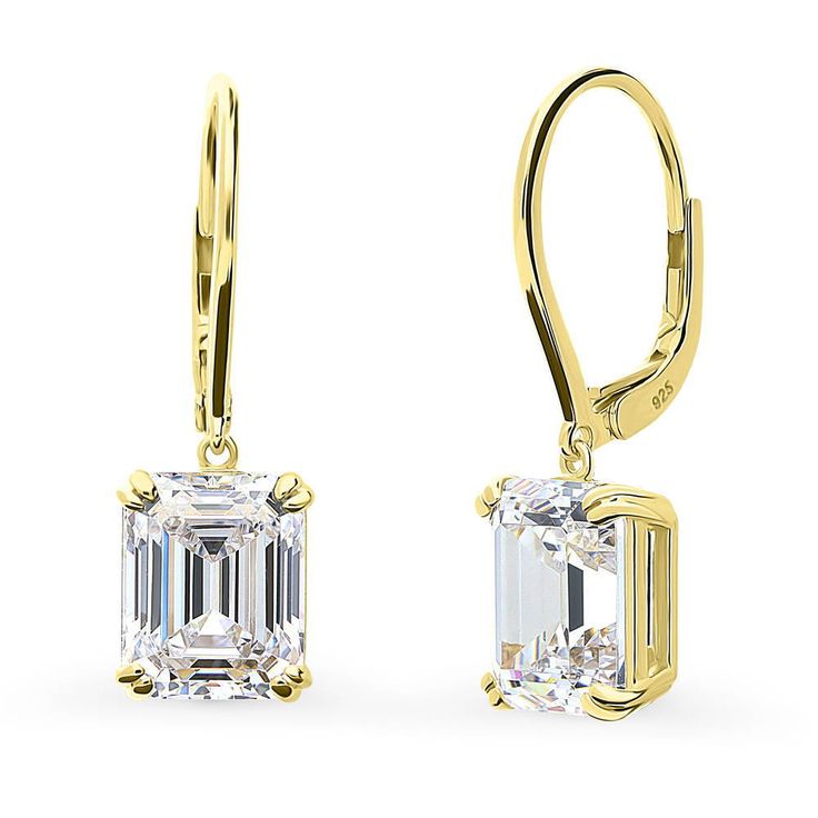 These solitaire dangle earrings are the very definition of good taste, featuring lustrous emerald-cut stones. The emerald cut is state of the art yet minimalistic. Often showcased on the red carpet, it emits radiance from every angle. If you appreciate sophistication, this one is for you. Crafted with sterling silver, yellow gold flashed, stamped 925. Set with premium quality 7.6 carat total (3.8 carat per stone, 10mm x 8mm) emerald cut cubic zirconia in 4-prong setting. Earrings measure 1" in l Emerald Diamond Earrings, Grade 7, Leverback Earrings, Inspired Jewelry, Emerald Cut Diamonds, Pinky Ring, Diamond Drop Earrings, Accessories Jewelry Earrings, Gemstone Engagement Rings