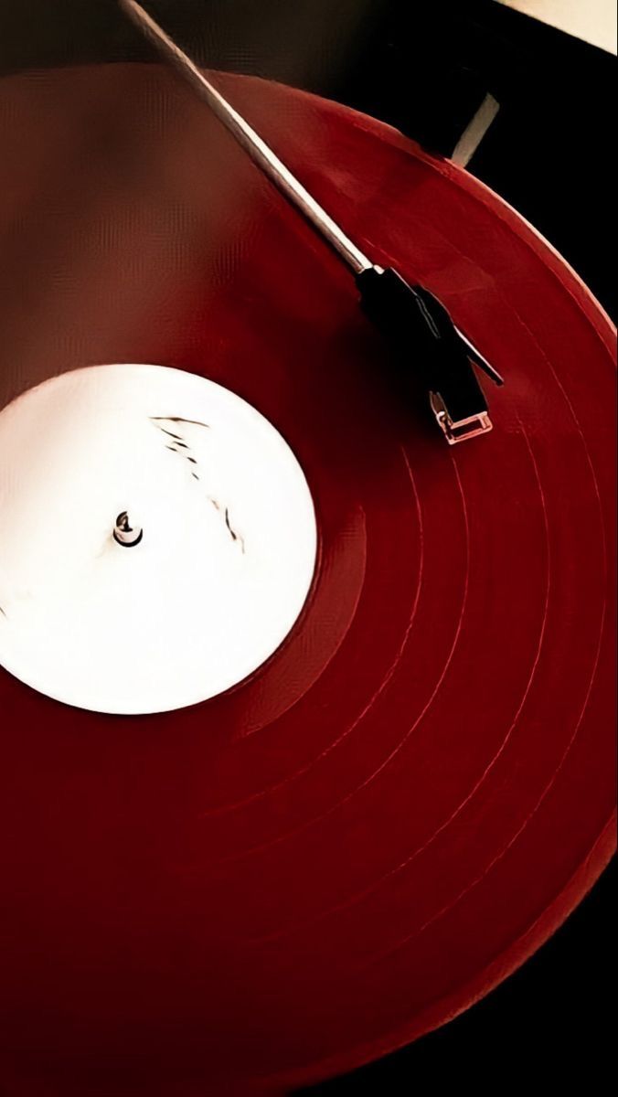 a red record with a black and white object on it