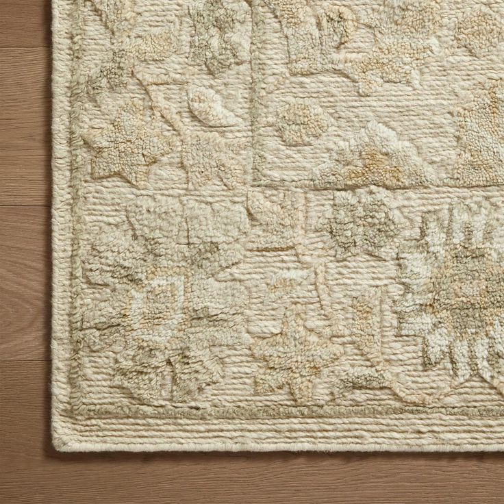 a white rug on top of a wooden floor