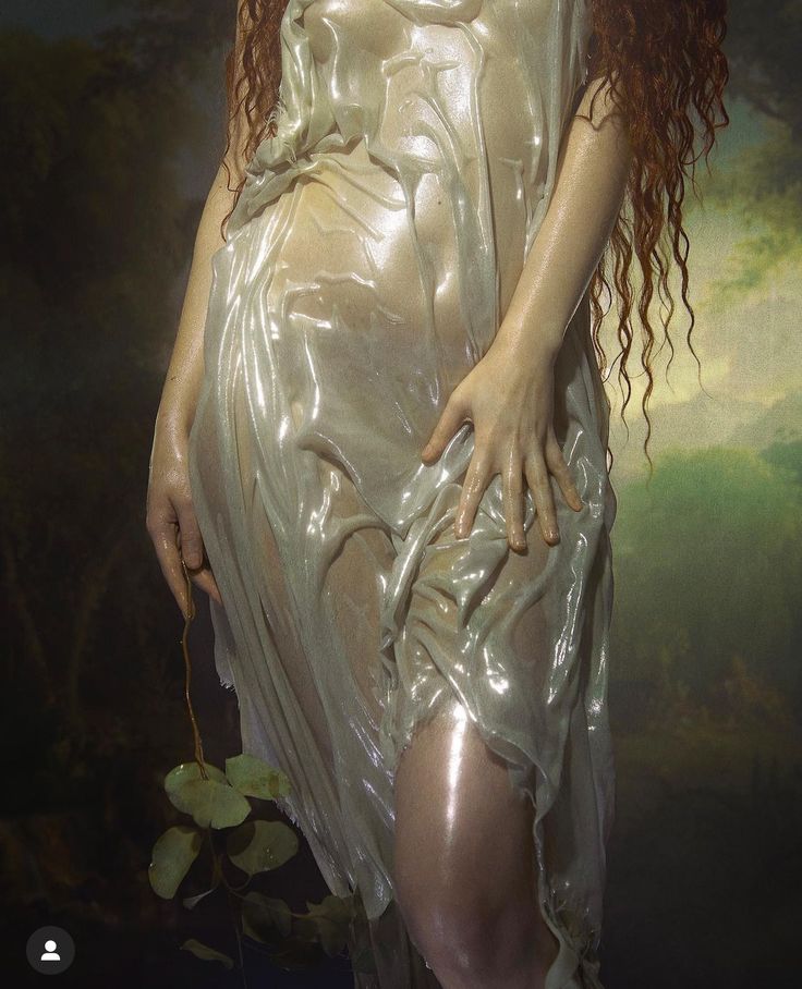 a woman with long red hair is wrapped in plastic and has her hands on her hips