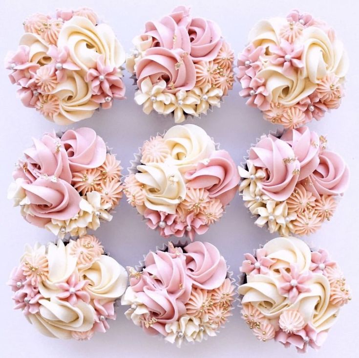 cupcakes with pink and white frosting are arranged in the shape of flowers