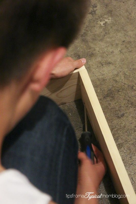 a man is using a screwdriver to fix a piece of wood