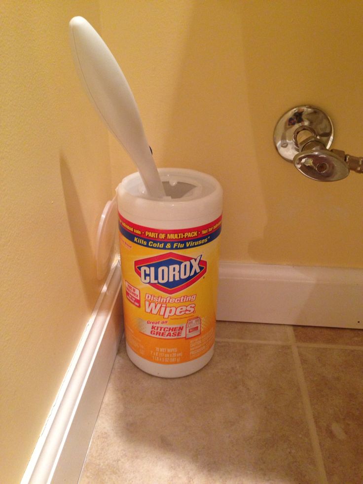 a can of clorox wipes sitting on the floor next to a door