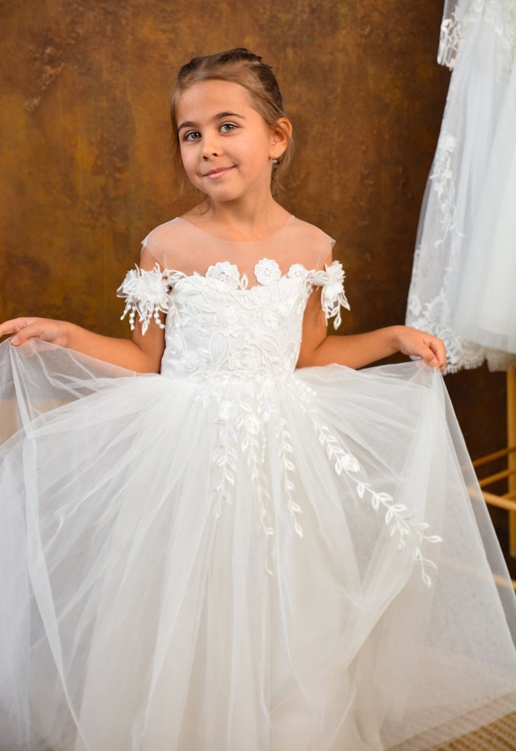 PERFECT FLOWER GIRL DRESS✨ Make order today and SAVE 15%🎁delivery 3-4 days only! Beautiful Baby Flower girl dress with shiny lace and amazing tulle sleeves! Process time: 1-2 working days Delivery time: 2-4 working days  Also offer express overnight delivery https://www.etsy.com/listing/1298332912/express-delivery?click_key=eb8207bd8376c2fa762384c4d5701f79c6bcbc77%3A1298332912&click_sum=63123b47&ga_search_query=express&ref=shop_items_search_1&frs=1 *Train is detachable & all dresses have bow* A First Communion Gown With Tulle Skirt, Tulle Tutu Dress With Lace Bodice For First Communion, Lace Bodice Ball Gown Pageant Dress, Lace Ball Gown Pageant Dress With Lace Bodice, Confirmation Princess Dress With Tulle Skirt, Wedding Tutu Dress With Lace Bodice, Confirmation Princess Dress Ball Gown With Tulle Skirt, Princess Ball Gown With Tulle Skirt For Confirmation, White Tulle Princess Dress With Floral Applique