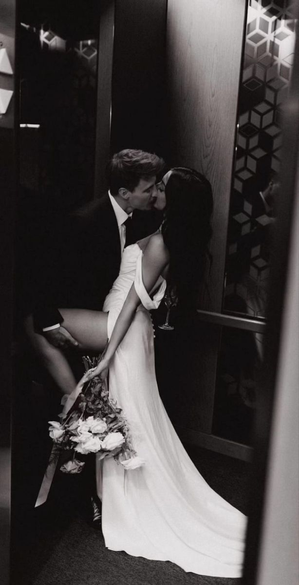 a man and woman kissing in an elevator