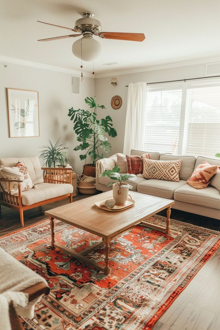 a living room filled with furniture and a large rug on top of a hard wood floor