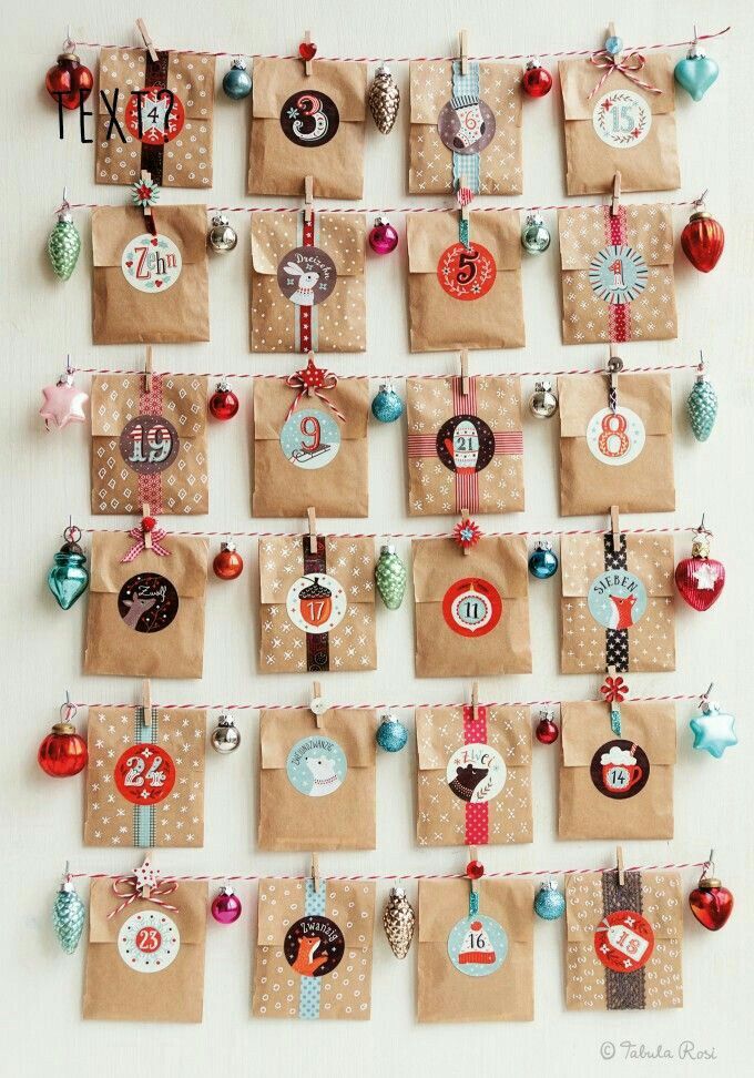 there are many bags hanging on the wall with christmas ornaments attached to each ornament