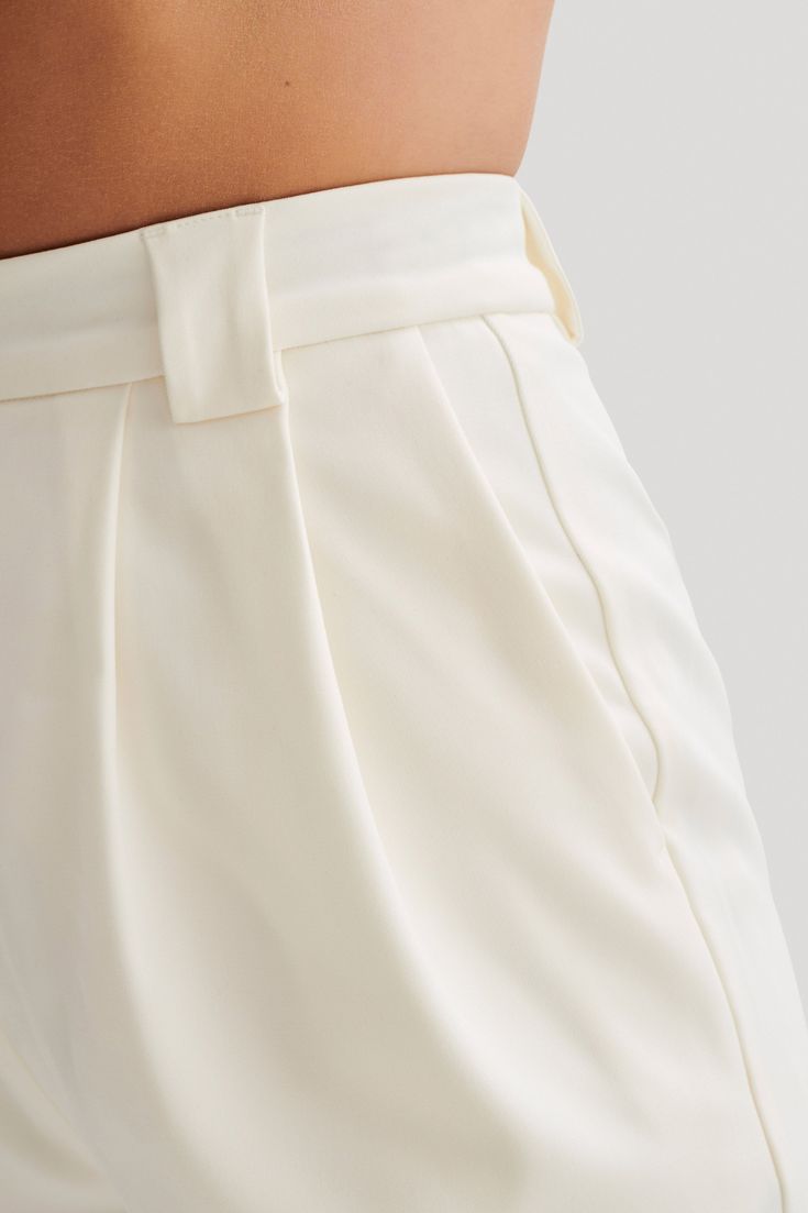 Short Staple.Discover the SIGOURNEY Suiting Shorts, a sophisticated addition to your wardrobe for effortless chic. Crafted with a relaxed fit and high-waisted design, these shorts offer both comfort and style. The front fly and trouser hook closure ensure a secure and polished fit, while the front pleat detailing adds a touch of refinement. Complete with a back mock welt pocket and belt loops, they exude timeless elegance with a contemporary twist. Unlined for lightweight wear, these shorts are Sloane Tailored Pant, Tailored Pants Women, Capsule Wardrobe Basics, Female Features, Maxi Dress Sale, Female Style, Wide Leg Pant, Leg Design, Tailored Pants