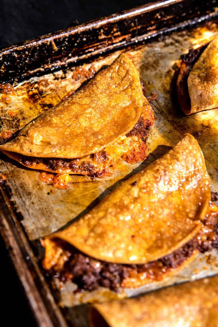 some food is sitting on a baking sheet and ready to be cooked in the oven