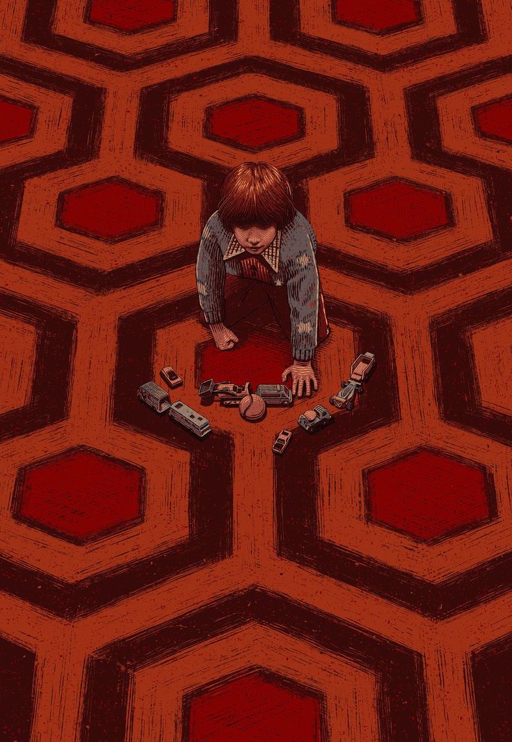 a person kneeling down in the middle of a room with red hexagons