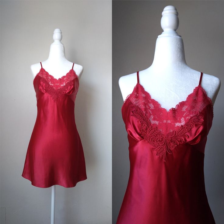 Vintage ruby red slip dress by Victoria's Secret.  Features lace along the neckline and a decorative motif on the center bust. Has a wonderful silky feel to it. The straps are adjustable. Era: Circa 1990s Condition: Excellent Size: XS Color: Ruby red Brand: Victoria's Secret Measurements: 15.5in pit to pit, 25in length excluding straps Fabric Content: 100% polyester (body); 86% nylon, 14% spandex (lace); 100% rayon (motif) Shown on a mannequin with a 33" bust, 26" waist, and 35" hips. Fits a size 2-4. Model is 5'5 with a 34A bust. Some garments may be clipped onto mannequin or model for display. MORE INFO: *Please, note that all items are vintage. Therefore, it is expected to find some wear. Ariessence by Ariel is an admirer of fashion history and hopes you can appreciate this garment and Red Spaghetti Straps Nightgown For Wedding Night, Coquette Lace Slip Dress For Night, Elegant Red Camisole Slip Dress, Fitted Delicate Lace Nightgown For Party, Red Lace Trim Sleep Dress, Elegant Red Camisole Sleepwear, Elegant Red Nightgown For Nighttime, Party Camisole Chemise With Lace Trim, Red Slip Dress With Spaghetti Straps For Night