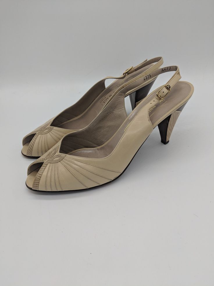 "Vintage 80's beige and brown leather peep-toe slingback heels by Bruno Magli. All real leather, made in Italy. Excellent condition, slight wear to the bottom of the sole but no other flaws found. Marked a size 8.5, but runs small. Best fits a size 7.5/8. Please check measurements. Length: 9.85\" Width: 3\" Heel height: 3.25\"" Beige Open Toe Leather Slingback Pumps, Beige Leather Open Toe Slingback Pumps, Beige Vintage Open Toe Sandals, Vintage Beige Open Toe Sandals, Retro Leather Slingback Heels, Beige Medium Width Open Toe Slingback Pumps, Beige Open Toe Slingback Pumps With Padded Heel, Beige Medium Width Slingback Pumps With Open Toe, Beige Slingback Pumps With Medium Width And Open Toe