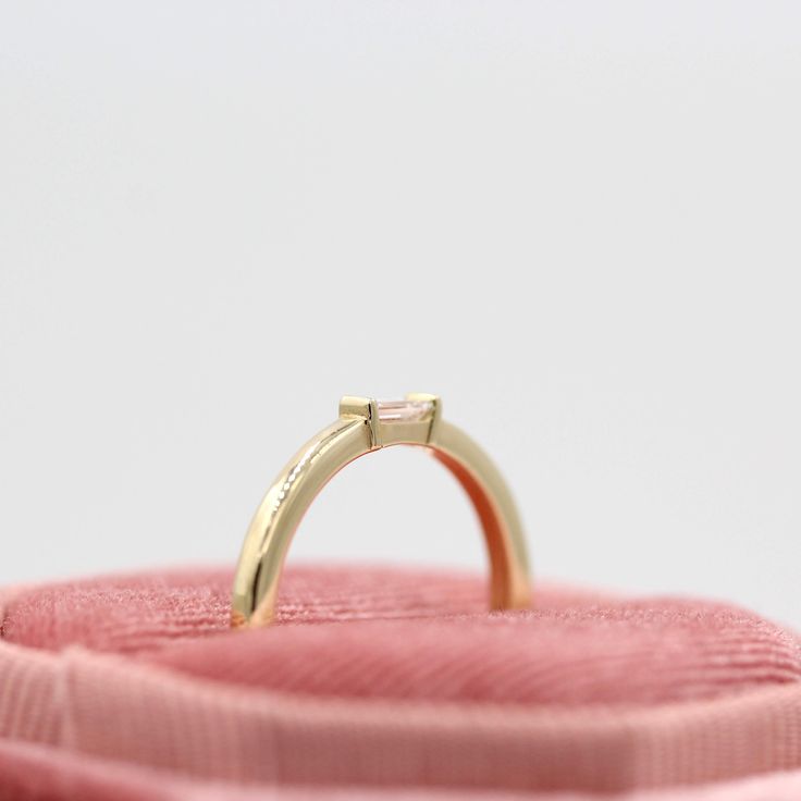 The Single Baguette Ring is versatile, minimal, and oh-so-classy. Featuring a single lab-grown baguette diamond, she is perfect alone, or stacks beautifully with other bands, such as our Christie Bands or any of our pavé bands. She's at home in a stack on your ring finger, or on a pointer finger, middle finger, or even a pinky! Details: 14k white, yellow, or rose gold, or platinum 0.12ct total weight — lab-grown diamonds 1.8mm band *Diamond is DEF color, VS1 clarity or better Modern Rings With Single Baguette Cut Diamond, Modern Solitaire Baguette Cut Diamond Ring, Minimalist Emerald Cut Diamond Ring With Single Cut Diamonds, Classic Baguette Rings For Everyday, Minimalist Emerald Cut Diamond Ring With Baguette Diamonds, Minimalist Single Diamond Baguette Cut Ring, Minimalist Emerald Cut Diamond Ring With Tension Setting, Minimalist Emerald Cut Yellow Gold Stackable Rings, Minimalist Emerald-cut Baguette Diamond Ring