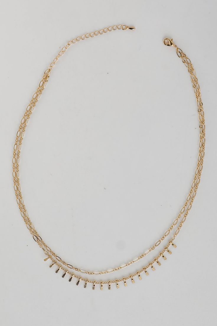 You'll always impress your admirers in the Kaia Gold Layered Chain Necklace! This trendy necklace features two layers of gold chains. Style the Kaia Necklace with any outfit to instantly upgrade your look! Gold Plated Layered Lobster Clasp with Extender Layer 1 | Length 6.5" Layer 2 | Length 6" Extender | Length 3" Trendy Multi-strand Layered Necklace With Double Chain, Gold Layered Charm Necklace Choker, Double Strand Metal Necklace With Delicate Chain, Metal Double Chain Layered Necklace, Gold Double Chain Layered Necklace, Trendy Gold Layered Double Chain Necklace, Gold-tone Layered Choker Necklace With Adjustable Chain, Trendy Gold Layered Necklace With Double Chain, Gold-tone Choker-style Layered Necklace With Adjustable Chain