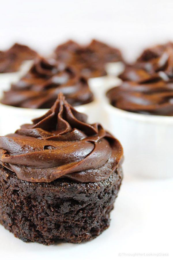 cupcakes with chocolate frosting in white cups