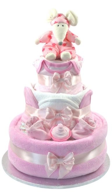 a pink and white diaper cake with a teddy bear on top